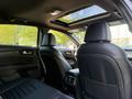 Interior view of a 2024 Kia Forte5 showcasing sleek black leather seats and a panoramic sunroof