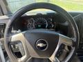 Steering wheel of a 2017 Chevrolet Express with controls and dashboard gauges visible in the background
