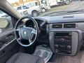 Interior view of a 2011 Chevrolet Avalanche featuring a steering wheel dashboard and audio controls