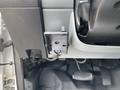 Interior view of a 2018 Ford F-750 dashboard showing a mounted black device with buttons and connectors near the steering column