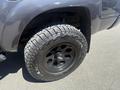 A 2010 Toyota Tacoma with a black wheel and rugged tire showcasing off-road tread pattern