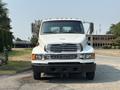 A 2006 Sterling Acterra truck with a white exterior and prominent front grille stands facing the viewer with side mirrors extended