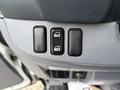 Three buttons on the door panel of a 2015 Mitsubishi Fuso FE160 labeled for locking and unlocking the vehicle doors