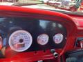 Dashboard of a 1962 Ford 2WHDR featuring white gauges for speed and temperature with a carbon fiber panel and a chrome lever on the right