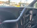 Close-up of a gear shift lever in a 2007 GMC C4500 TopKick interior with a black handle and surrounding controls visible