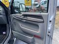 Interior view of the driver's side door of a 2007 Ford F-350 SD featuring a gray panel with controls for windows and locks