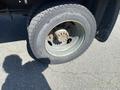 Close-up of a tire and wheel from a 1996 GMC Top Kick showing significant wear and rust on the rim and visible tread pattern on the tire