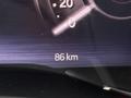 A dashboard display showing the speedometer with the needle pointing to 86 km