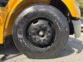 A black wheel of a 2011 Freightliner B2 bus featuring a Goodyear tire with a tread pattern and visible lug nuts