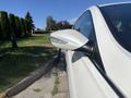 A white 2015 Hyundai Sonata featuring a sleek side mirror with integrated turn signal lights