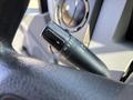 Close-up of a black turn signal lever on the steering column of a 2018 Ford F-750 showing indicators for turn signal and potentially wiper settings