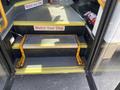 A 2020 Chevrolet Express with an open door showing a step stool labeled "Watch Your Step" positioned on the steps leading inside the vehicle