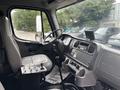 Interior view of a 2006 Freightliner M2 106 showing the driver's seat steering wheel dashboard and gear controls