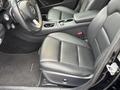 Interior view of a 2016 Mercedes-Benz GLA-250 featuring black leather seats and a sleek dashboard design
