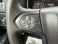 Close-up of the steering wheel controls in a 2018 Chevrolet Silverado 1500 featuring buttons for cruise control settings including resume set and a switch for various functions