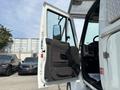 White 2012 International 7300 Workstar truck with an open door showing the interior features and dashboard