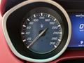 Speedometer of a 2016 Maserati Ghibli indicating speed in kilometers per hour with a central Maserati logo