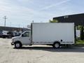 A 2019 Ford Econoline van with a large white cargo box is parked with its side visible