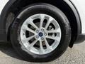 Close-up of a wheel and tire from a 2020 Ford Escape featuring a silver alloy rim and a Continental ProContact tire with visible brake components