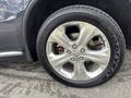 A close-up of a chrome alloy wheel from a 2015 Dodge Durango featuring five spokes and a Goodyear tire with prominent tread patterns