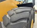 Close-up of a large tire from a 2012 Caterpillar 980 wheel loader showcasing its rugged tread pattern and robust design