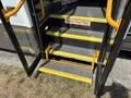 A set of yellow stairs leading up to the entrance of a 2020 Chevrolet Express with a black exterior