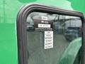 A close-up of a sticker on the window of a 2013 Kenworth T370 displaying a certificate of approval and various month labels