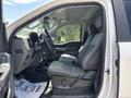 Interior view of a 2021 Ford F-150 showing front seats and dashboard with gray fabric upholstery and modern controls