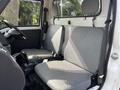 Interior view of a 2010 Daihatsu Hijet showing two gray fabric seats and a simple dashboard design