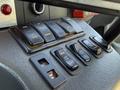 Close-up of the dashboard controls in a 2020 Chevrolet Express featuring various buttons for doors fan and auxiliary functions