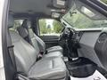 A 2014 Ford F-550 interior showcasing gray leather seating and a modern dashboard with controls and display features