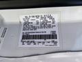 A white sticker on the inside of a vehicle door with vehicle specifications and details for a 1995 Ford F-250 truck