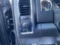 Close-up of the dashboard controls in a 2017 RAM 1500 featuring knobs for lighting and air conditioning settings