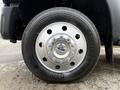 A close-up of a silver wheel with a multi-spoke design branded with the Ford logo on a black tire marked with the Continental name