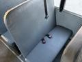 A gray bench seat with black seat belts in a 2014 International 4300 vehicle