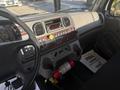 Interior dashboard of a 2022 Freightliner M2 106 featuring controls gauges and a radio with detailed paneling and a fire extinguisher mounted below