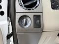 Close-up of the dashboard controls of a 2008 Ford F-450 SD including knobs for lights and a switch for auxiliary functions