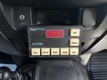 Control panel of a 2017 Ford F-550 featuring buttons for audio and light functions along with a red digital display