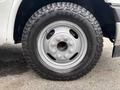 A close-up of a Goodyear tire mounted on a silver wheel of a 2020 Chevrolet Express van