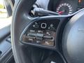 Close-up of the control buttons on the steering wheel of a 2019 Mercedes-Benz Sprinter showing features for cruise control and settings