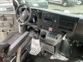 Interior view of a 2020 Chevrolet Express van showing the dashboard seating area and control panel