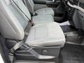 A 2021 Ford F-150 featuring gray cloth seats with a textured pattern and seatbelts in a modern interior setting