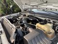 An open hood of a 2009 Ford F-550 revealing the engine with various components including hoses, reservoirs, and an air intake system