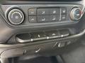 A close-up view of the control panel in a 2016 Chevrolet Silverado 2500HD displaying air conditioning and temperature adjustment buttons