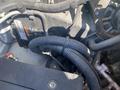 2011 Chevrolet Express engine compartment with visible components including battery wires and hoses