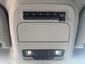 Interior overhead console of a 2023 Ford F-350 SD featuring six auxiliary switches and two lights