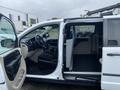 A 2014 RAM Cargo Van showing the interior with a driver's seat, passenger seat, and a cargo area configured for storage and utility purposes