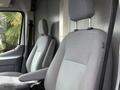 Two gray fabric seats inside a 2017 Ford Transit van with adjustable headrests and a simple ergonomic design