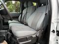 Front seats of a 2016 Ford F-550 Super Duty with gray fabric upholstery and seat belts visible