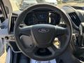 Interior view of a 2016 Ford Transit showing the steering wheel and dashboard with a speedometer and controls
